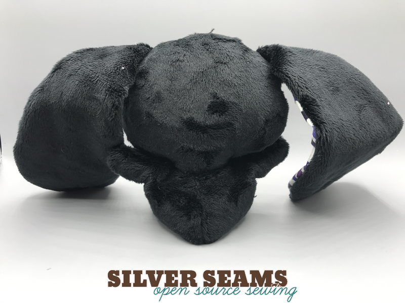 The back of the bunny, all black plush, a better angle on just how much slack there is in the ears at this length.