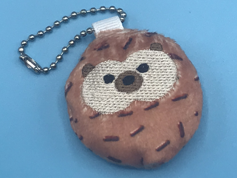 A hedgehog charm with printed-fabric sprinkles for prickles