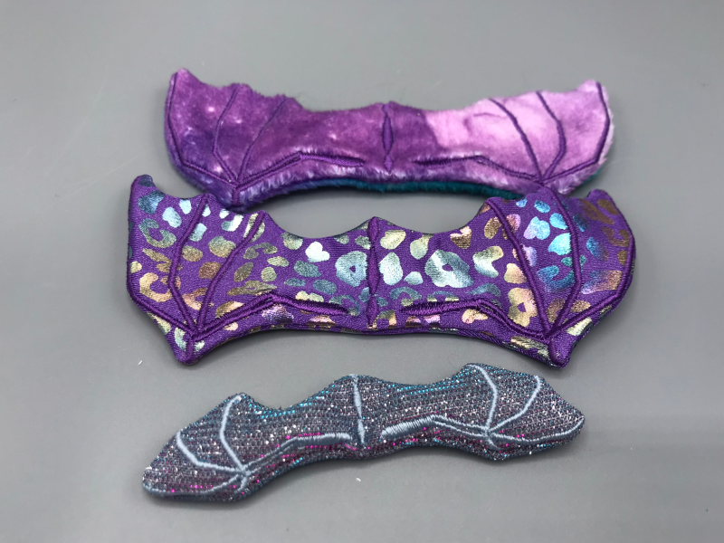 Three different purple dragon wings