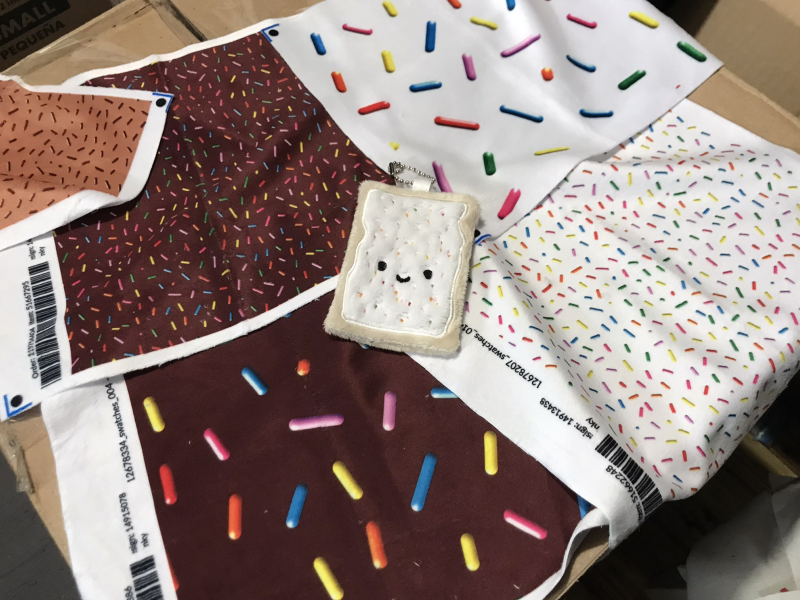 The embroidered toaster pastry, on samples of printed minky with various sprinkles designs