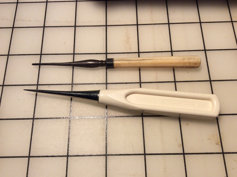 An antique tailor&#39;s awl compared to a new one.