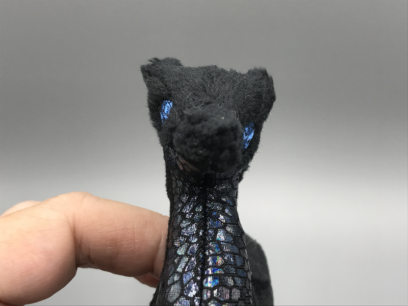 A face-on view of the dragon. The eye on the other side is halfway down the head, entirely asymmetrical.