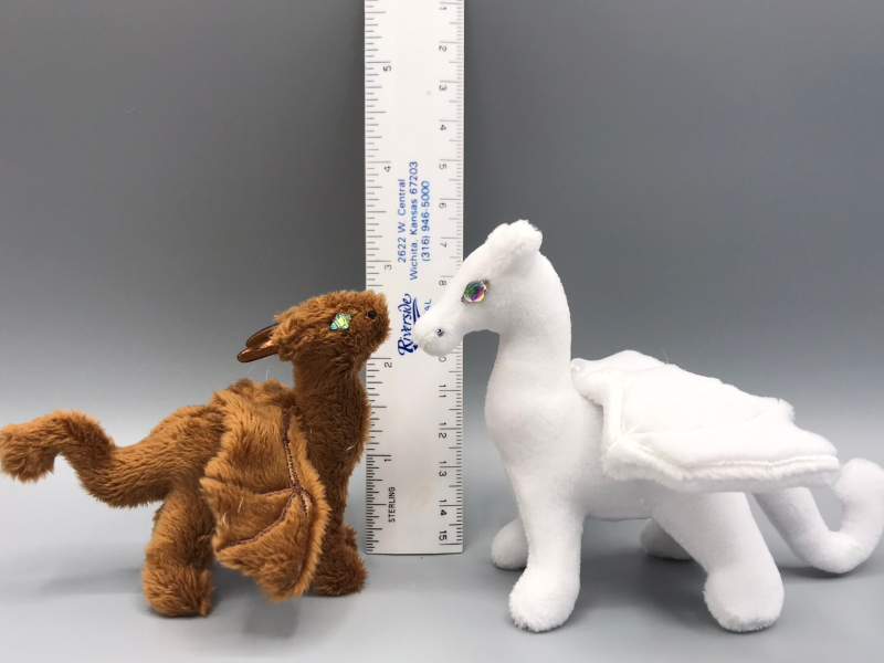 A small &quot;adult&quot; dragon next to a small &quot;baby&quot; dragon of approximately the same height